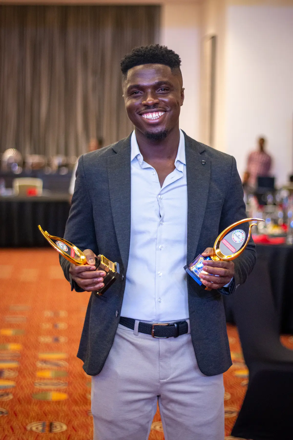 A Beyond the Science representative standing with two ESG and Sustainability Awards