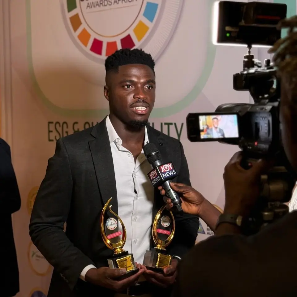 A Beyond the Science representative holding two awards during a media interview at the 2025 ESG and Sustainability Awards