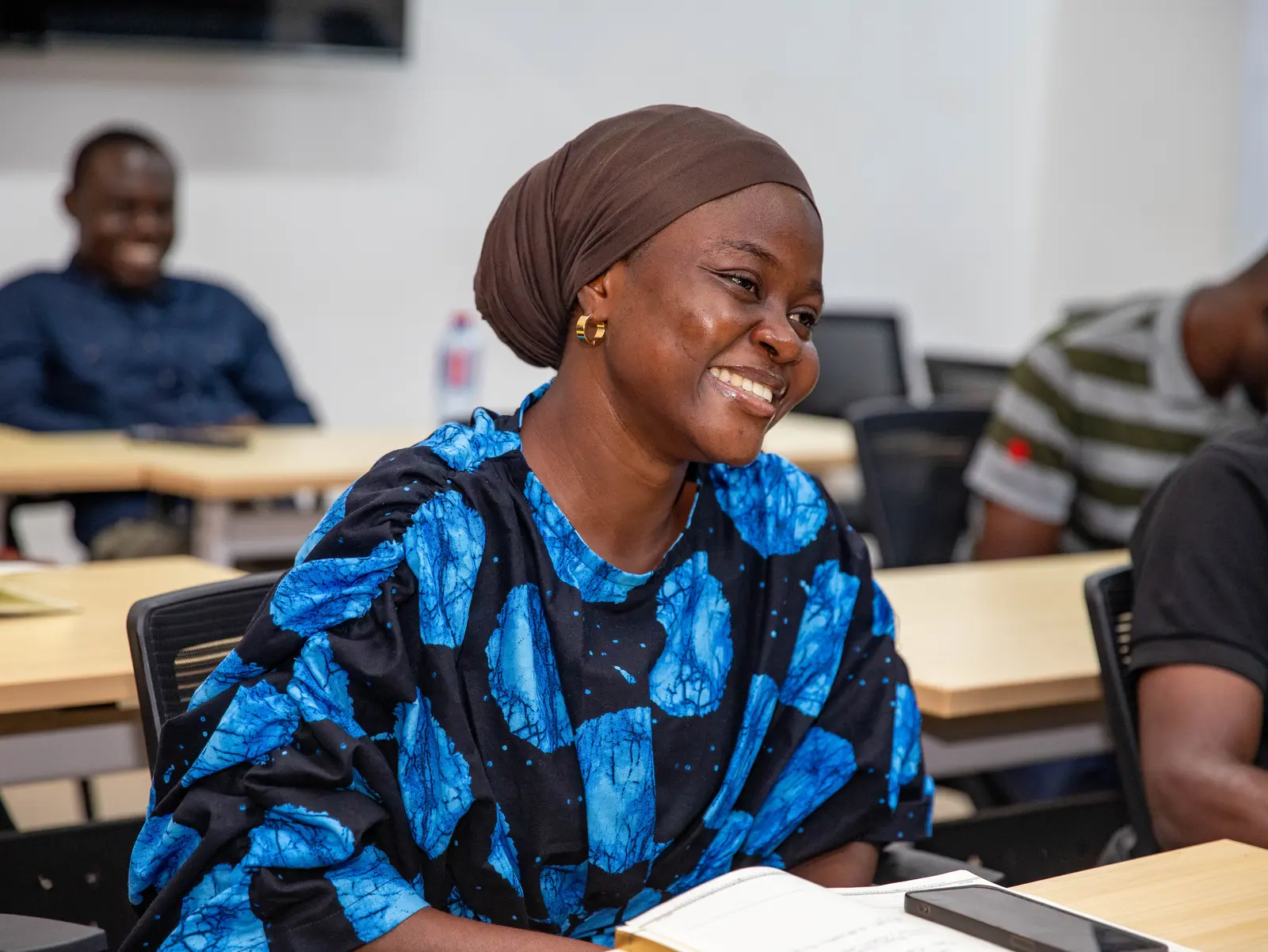 A BTS participant smiling during a collaborative workshop