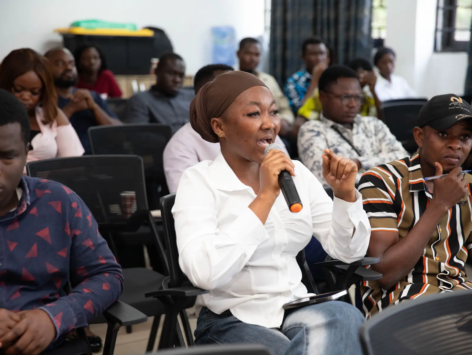 A participant speaking into a microphone