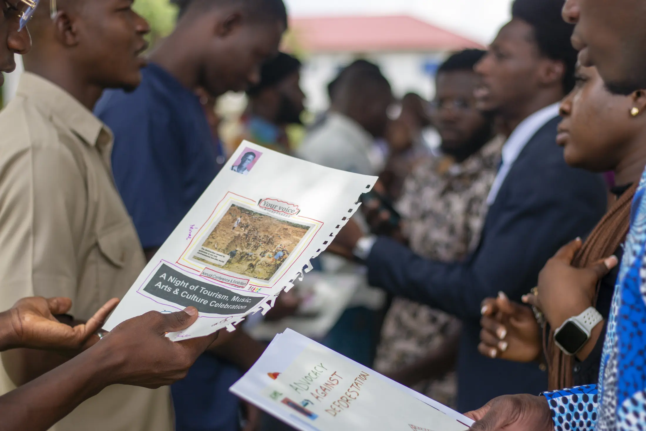 Young climate leaders reviewing community research materials